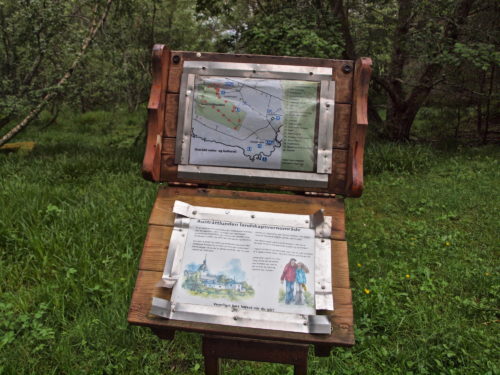 Austrått, Austråttlunden, the grove of Austrått, a information board against a green background